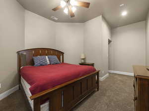 Bedroom featuring dark carpet and ceiling fan