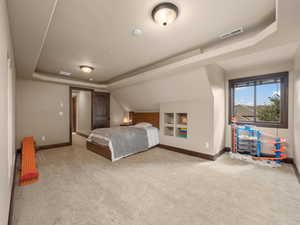 Bedroom featuring a textured ceiling and a raised ceiling