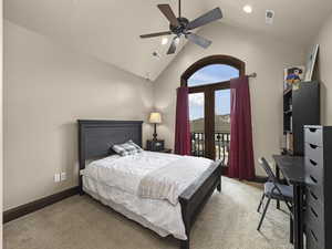 Carpeted bedroom with access to outside, high vaulted ceiling, and ceiling fan