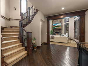 Interior space with a stone fireplace and hardwood / wood-style flooring