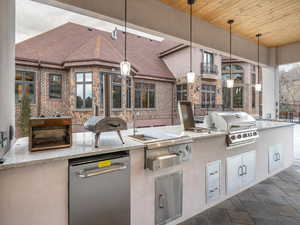 View of patio featuring exterior kitchen and grilling area