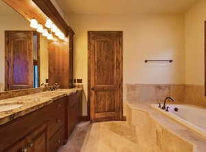 Bathroom featuring vanity and tiled tub