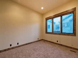 Empty room with light colored carpet