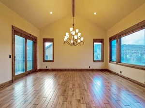 Interior space featuring high vaulted ceiling, beamed ceiling, a chandelier, and light wood-type flooring