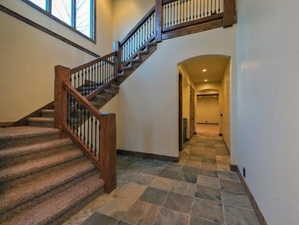 Stairs featuring a towering ceiling