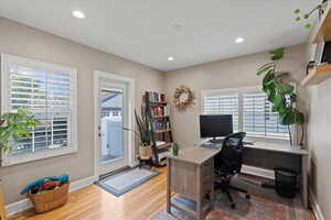 Office/ bedroom with light hardwood / wood-style flooring and a wealth of natural light