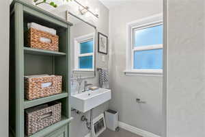 Bathroom featuring sink and beautiful baskets.