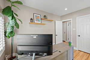 Home office/ bedroom with light hardwood / wood-style flooring