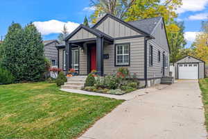 View of front of house with a garage, and a front lawn