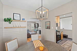 Dining space featuring hardwood / wood-style floors and a notable chandelier