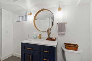 Newly remodeled bathroom with vanity, toilet, and tile patterned floors