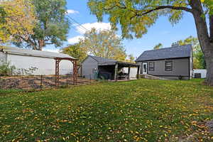 View of yard featuring a covered patio and big garden.