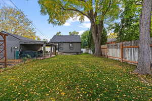 View of yard featuring a covered patio area and big garden.