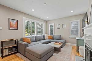 Living room with light hardwood / wood-style floors