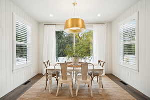 Dining room with dark wood-type flooring