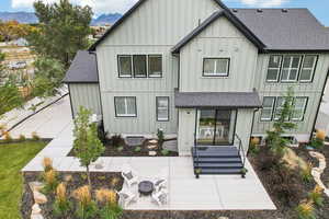 Rear view of property with a patio area, a mountain view, a fire pit, and central AC unit