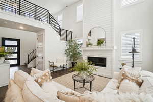 Living room with a wealth of natural light and a high ceiling