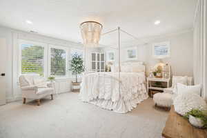 Carpeted bedroom with ornamental molding