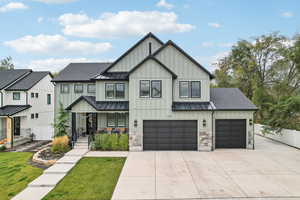 View of front of property featuring a front lawn and a garage