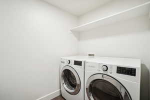 Washroom featuring washer and dryer and wood-type flooring