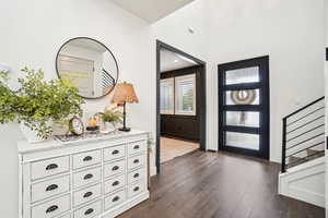 Entrance foyer featuring dark hardwood / wood-style floors