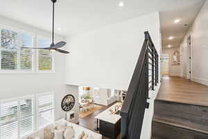 Living room with wood-type flooring and ceiling fan