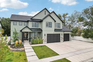 Modern inspired farmhouse with a front yard and a garage