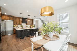 Dining area with a textured ceiling, sink, and dark hardwood / wood-style floors