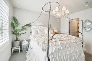 Bedroom featuring carpet and a chandelier