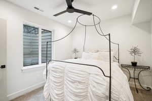 Carpeted bedroom featuring ceiling fan