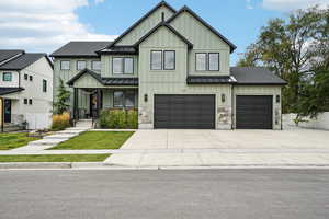 View of front of property with a front yard and a garage