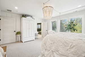 Bedroom featuring a textured ceiling and carpet flooring