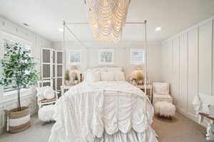 Bedroom with crown molding, multiple windows, and carpet floors