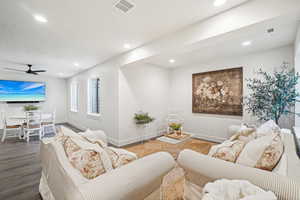 Living room featuring ceiling fan and hardwood / wood-style floors