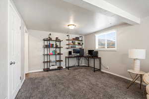 Carpeted office featuring a textured ceiling