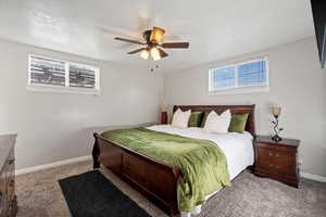 Bedroom featuring ceiling fan and light carpet