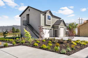 View of front of property with a mountain view and a garage