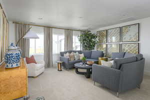 Living room featuring a textured ceiling and carpet floors