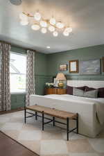 Bedroom with hardwood / wood-style flooring and a textured ceiling