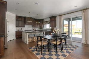 Dining space featuring dark hardwood / wood-style flooring, sink, and plenty of natural light