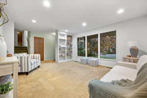 Carpeted living room featuring built in shelves