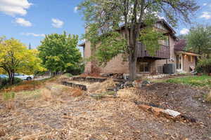 View of property exterior with central AC unit