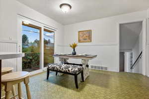 Dining space featuring wood walls