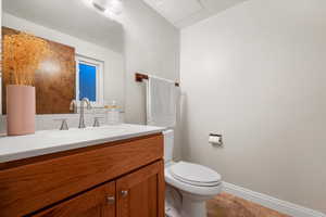 Bathroom with toilet, vanity, and tile patterned flooring