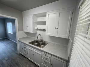 Kitchen featuring sink, dark hardwood / wood-style floors, and white cabinets