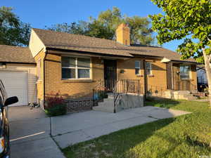 Single story home featuring a front lawn and a garage