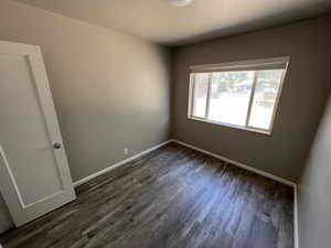 Unfurnished room featuring dark hardwood / wood-style floors