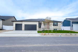 View of front of house with a front yard and a garage