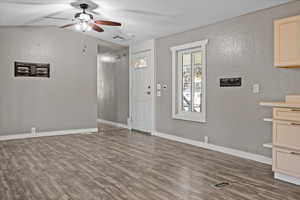 Interior space with ceiling fan, wood-type flooring, and lofted ceiling