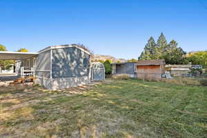 Exterior space with a mountain view and a lawn